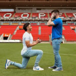 Photo: Adelaide United Player Engages with Partner on Football Field