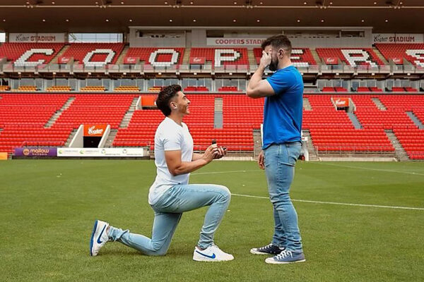 Photo: Adelaide United Player Engages with Partner on Football Field